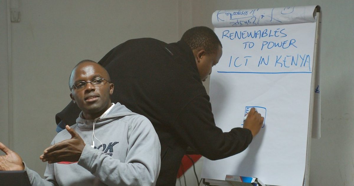 Facilitator writing on a flip chart during a business workshop in Kenya