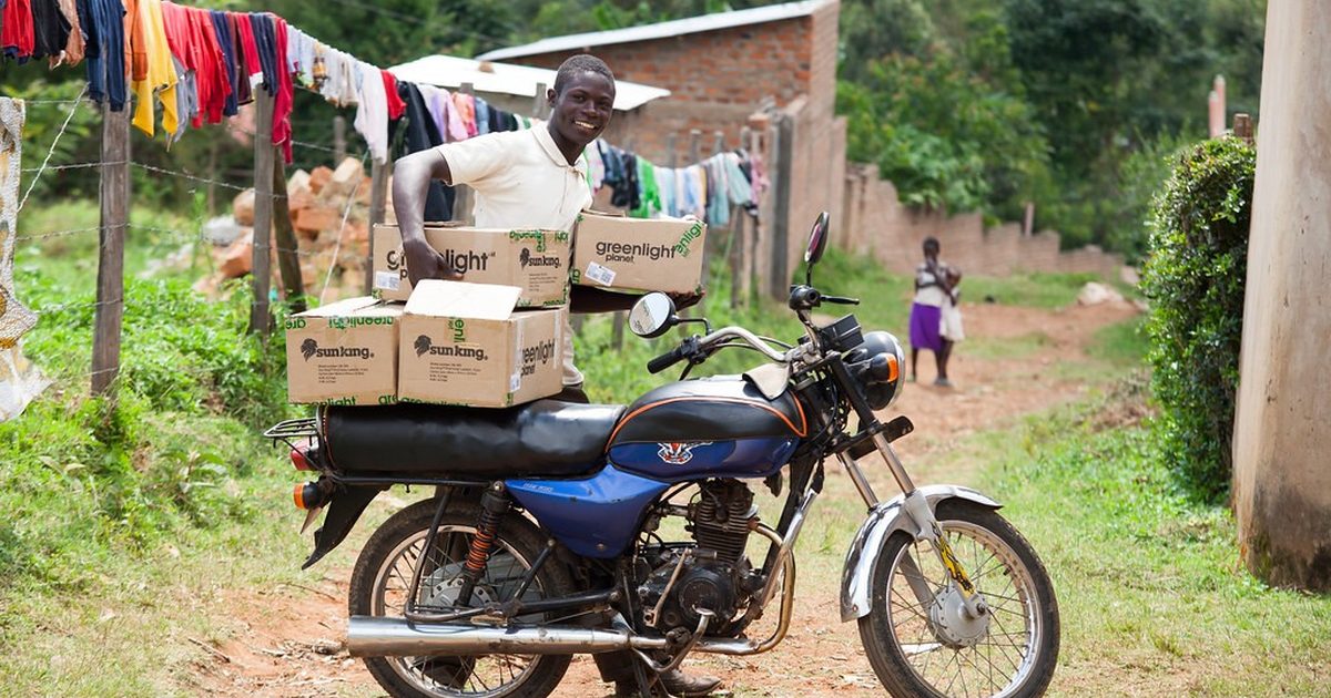 Delivery motorbike loaded with parcels outside a home in Kenya