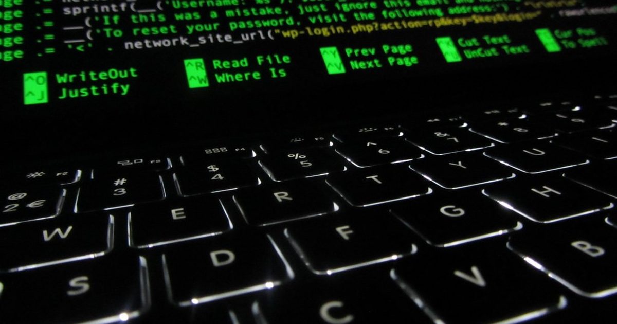 Backlit laptop keyboard with code on the screen