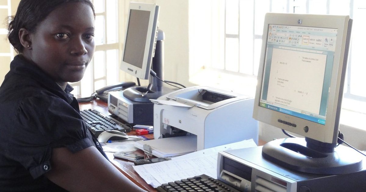 Office worker at a desktop computer in a Kenyan office