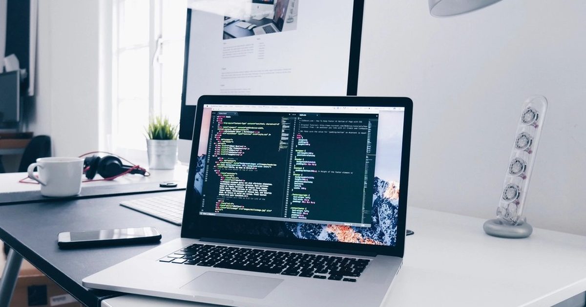 Laptop with source code open on a clean desk